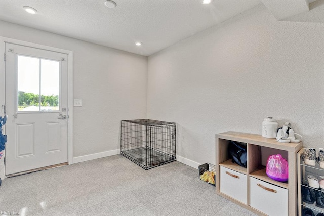 interior space with baseboards, recessed lighting, and a textured ceiling