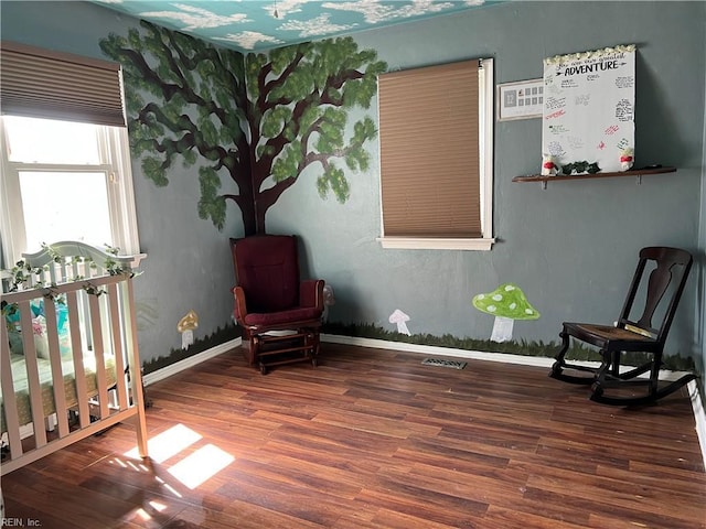 sitting room featuring baseboards and wood finished floors
