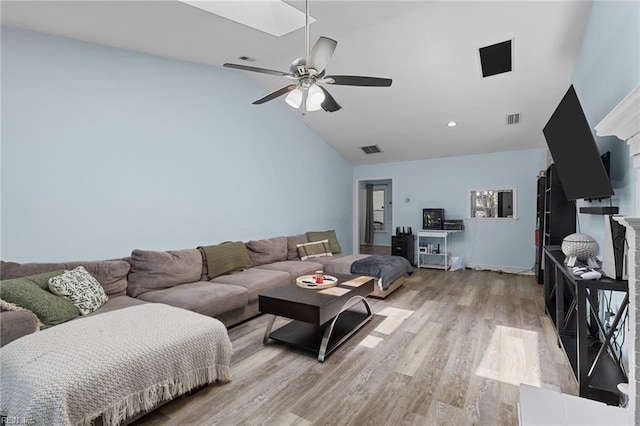living area with light wood-type flooring, a ceiling fan, visible vents, and high vaulted ceiling
