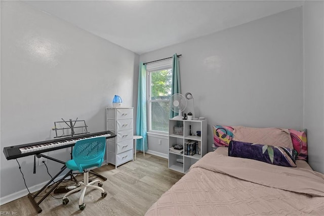 bedroom featuring baseboards and wood finished floors