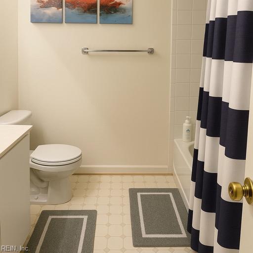 bathroom featuring toilet, baseboards, tile patterned floors, and vanity