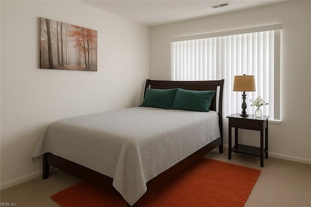 carpeted bedroom featuring baseboards and visible vents