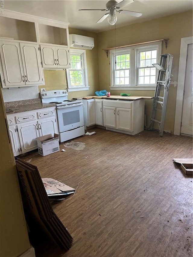 kitchen featuring a wall mounted air conditioner, ceiling fan, dark wood-type flooring, white cabinetry, and electric stove