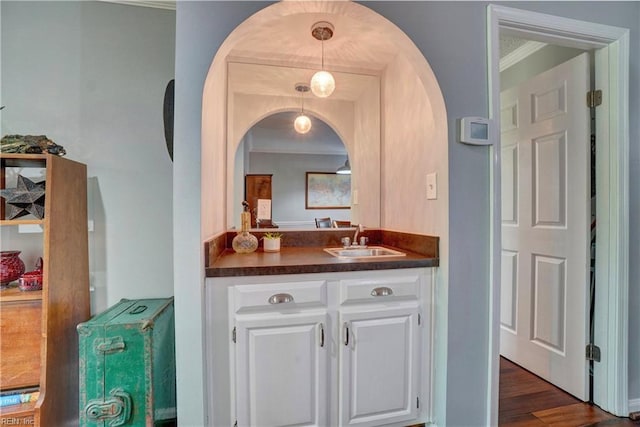 255 College Cross Unit 87, Norfolk, VA 23510 - interior space featuring pendant lighting, arched walkways, a sink, ornamental molding, and dark wood-type flooring