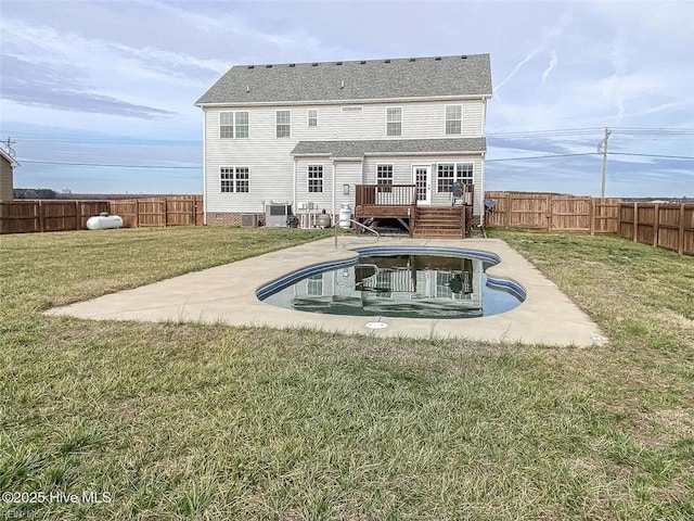 rear view of house with a fenced in pool, a fenced backyard, a yard, and a deck
