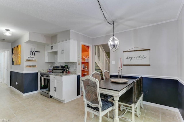 kitchen with light tile patterned flooring, white cabinets, light stone counters, a notable chandelier, and stainless steel electric range oven