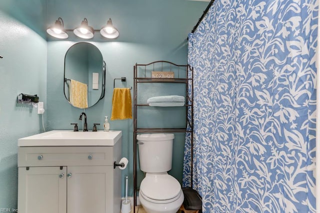 bathroom with toilet and vanity