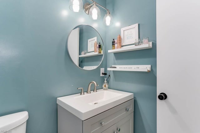 half bathroom with toilet and vanity