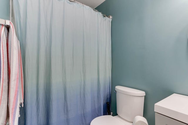 bathroom with a shower with curtain and toilet