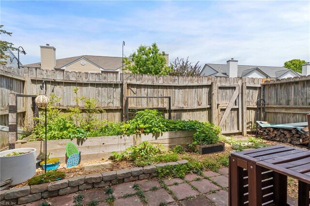 view of yard featuring fence, a gate, and a garden
