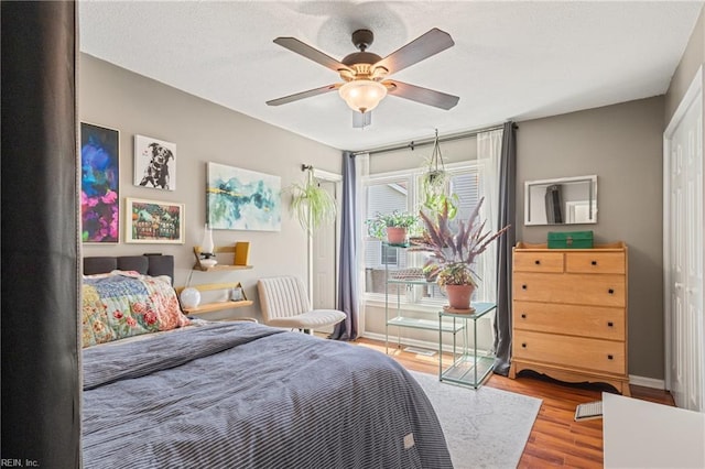 bedroom featuring a ceiling fan and wood finished floors