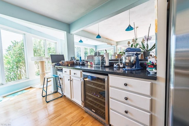 12 Rudee Ave, Virginia Beach, VA 23451 - bar featuring freestanding refrigerator, pendant lighting, wine cooler, beamed ceiling, and light wood finished floors
