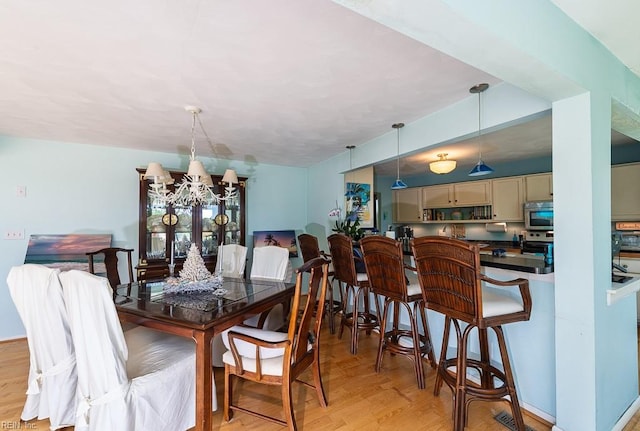12 Rudee Ave, Virginia Beach, VA 23451 - dining room featuring a notable chandelier and light wood-style floors