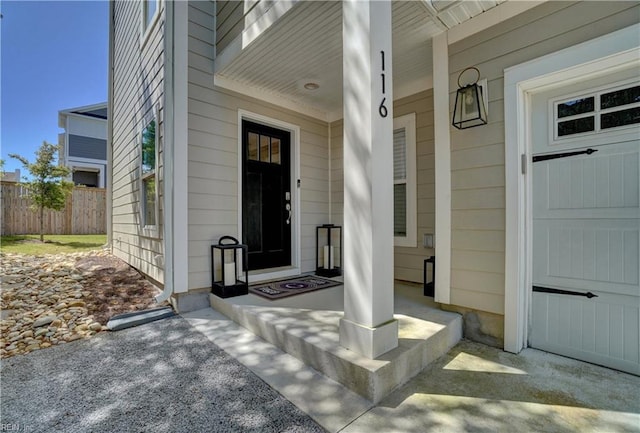 view of exterior entry with fence