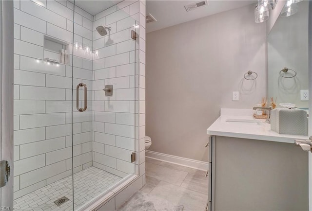 full bathroom with visible vents, a stall shower, vanity, baseboards, and toilet