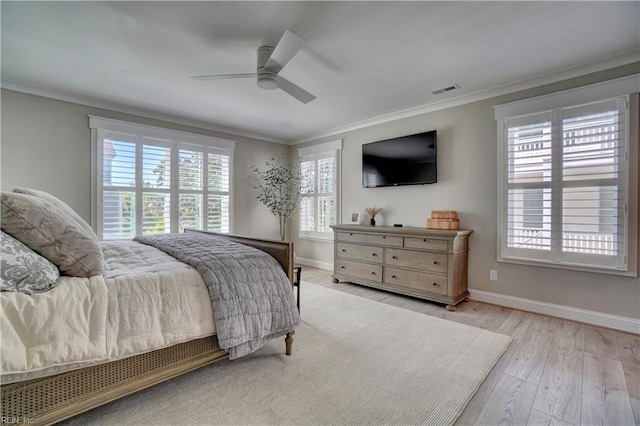 bedroom featuring crown molding, baseboards, wood finished floors, and visible vents