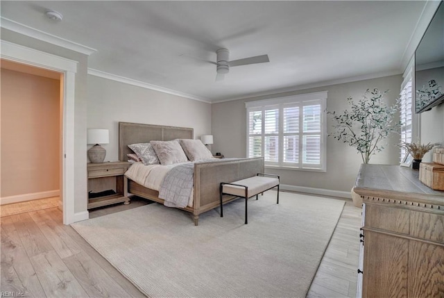 bedroom with light wood-type flooring, ornamental molding, baseboards, and ceiling fan