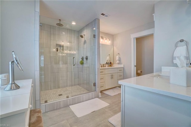 full bathroom featuring vanity, tile patterned floors, recessed lighting, visible vents, and a stall shower