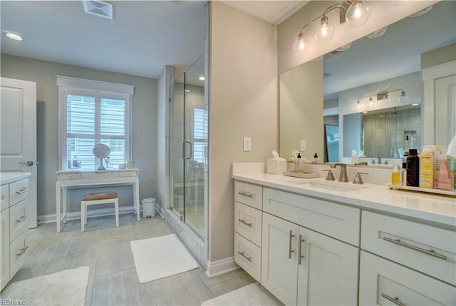 bathroom with vanity, recessed lighting, baseboards, visible vents, and a stall shower