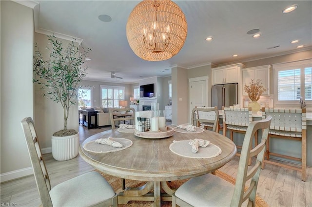 dining room featuring ornamental molding, baseboards, recessed lighting, a chandelier, and light wood-style flooring