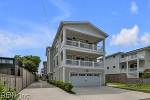 view of front of house with fence, driveway, a balcony, and a garage