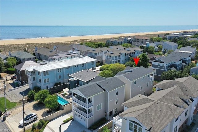 birds eye view of property with a water view, a residential view, and a beach view
