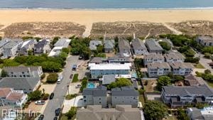 aerial view featuring a residential view, a view of the beach, and a water view