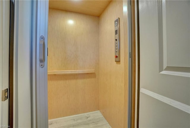 room details with wood finished floors and elevator
