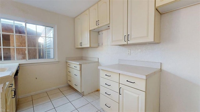 kitchen featuring light tile patterned floors, baseboards, and light countertops
