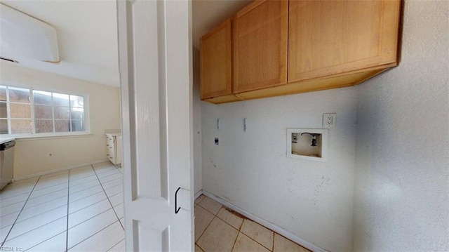 laundry area featuring cabinet space, electric dryer hookup, hookup for a washing machine, and light tile patterned flooring