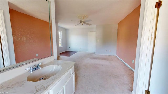 bathroom featuring baseboards, ceiling fan, and vanity