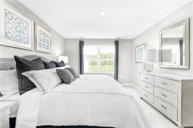 bedroom featuring baseboards and light carpet