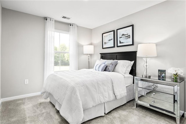 bedroom with baseboards, carpet floors, and visible vents