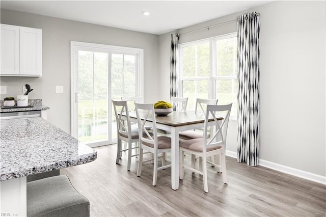 dining area featuring recessed lighting, baseboards, and light wood finished floors