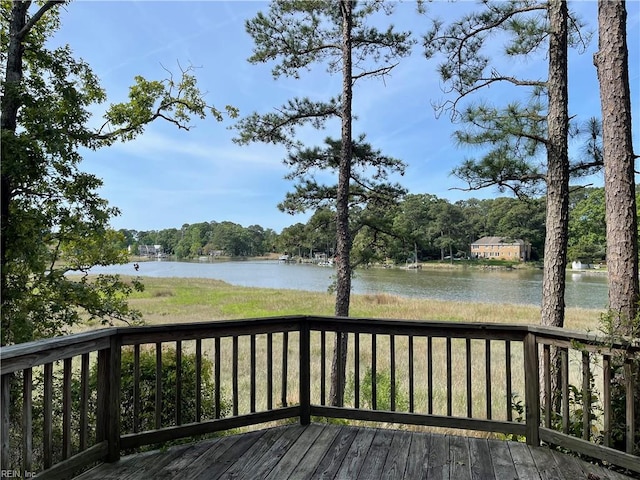 wooden terrace featuring a water view