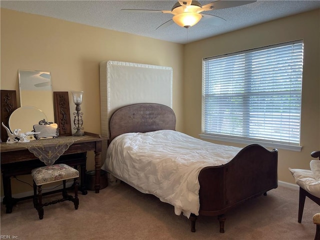 bedroom with carpet floors, a textured ceiling, and ceiling fan