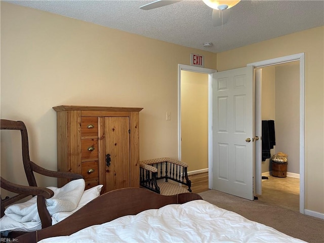 bedroom with baseboards, a ceiling fan, carpet flooring, and a textured ceiling