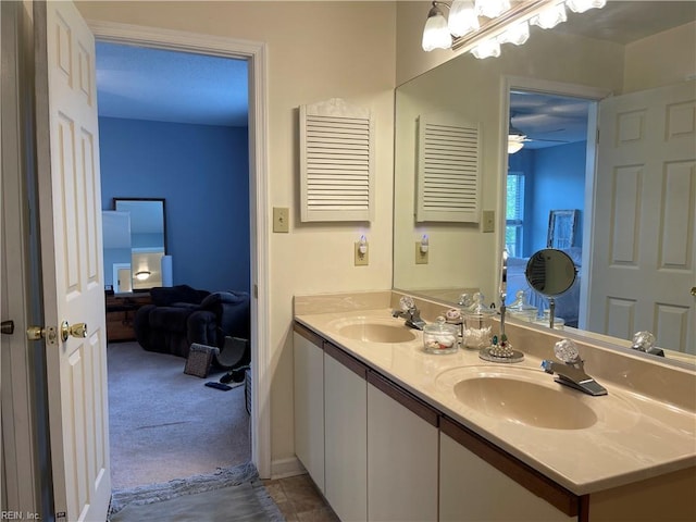 full bath with a sink, ensuite bathroom, a ceiling fan, and double vanity