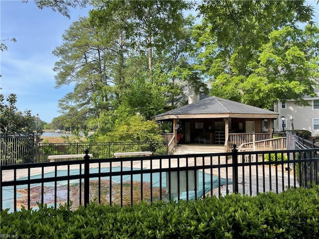 community pool with fence and a patio