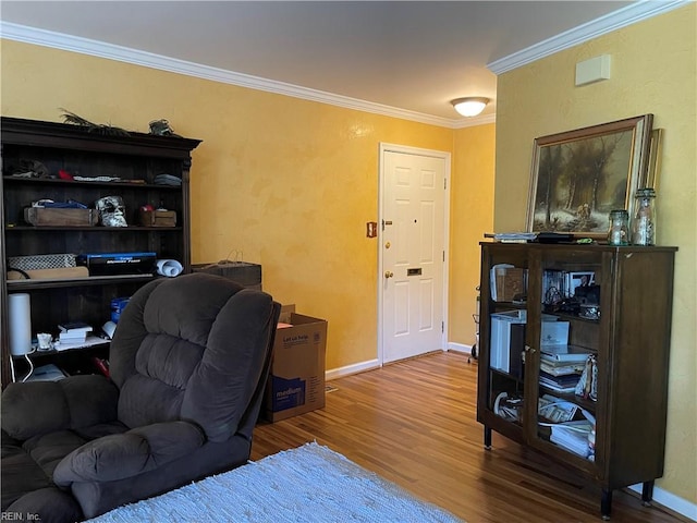 office space featuring crown molding, baseboards, and wood finished floors