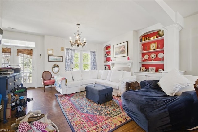 422 New London Pl, Virginia Beach, VA 23454 - living room featuring built in shelves, ornate columns, wood finished floors, and a notable chandelier