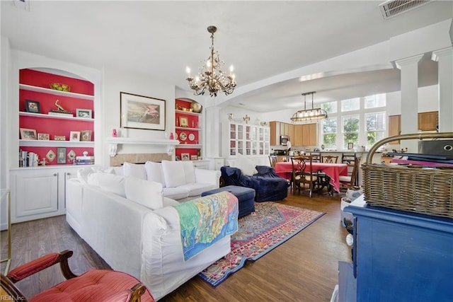 422 New London Pl, Virginia Beach, VA 23454 - living room with decorative columns, visible vents, wood finished floors, built in shelves, and an inviting chandelier