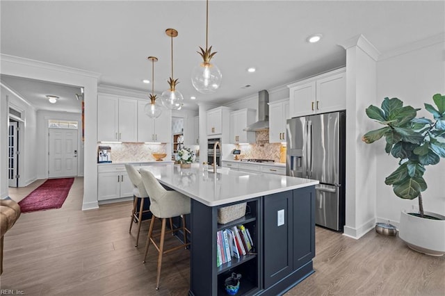 kitchen featuring open shelves, wall chimney range hood, light countertops, white cabinets, and appliances with stainless steel finishes