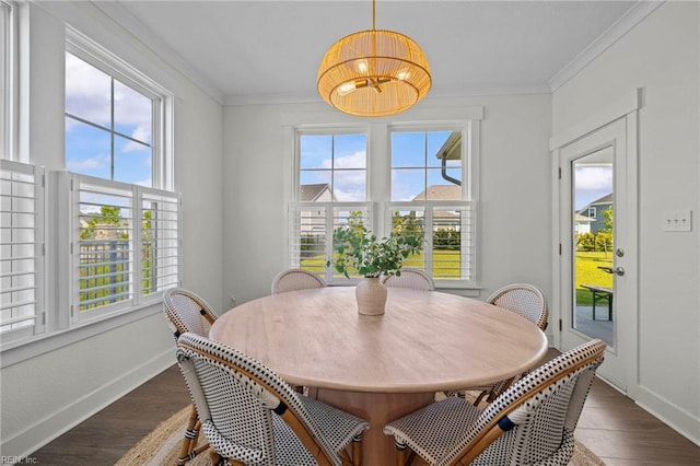 dining area with crown molding, baseboards, dark wood-type flooring, and a notable chandelier