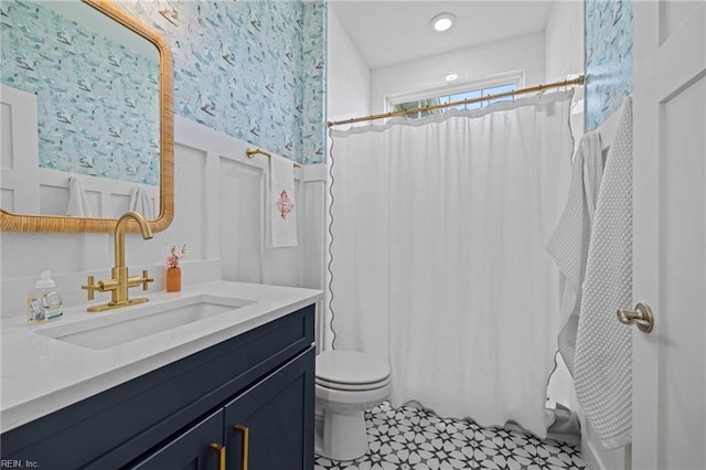 bathroom featuring vanity, tile patterned flooring, toilet, and curtained shower