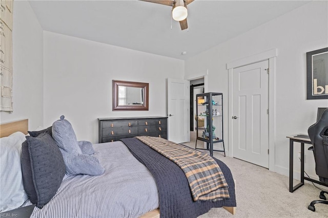 bedroom featuring baseboards, a ceiling fan, and light carpet
