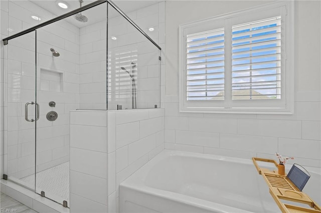 bathroom with a garden tub and a shower stall