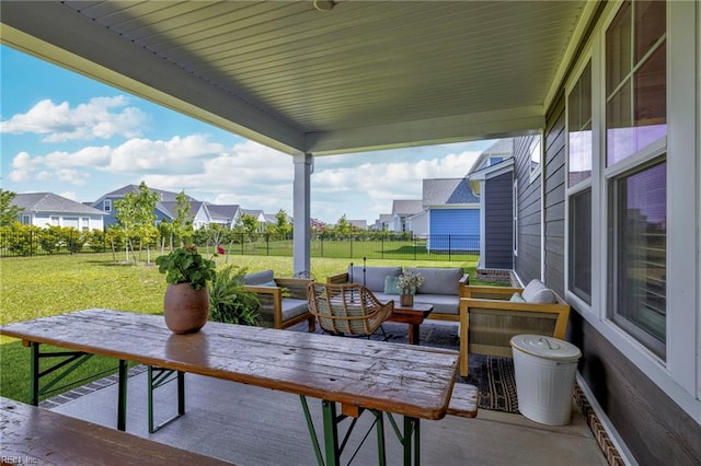view of patio with fence, outdoor lounge area, and a residential view