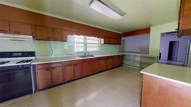 3702 Nansemond Pkwy, Suffolk, VA 23435 - kitchen with range with gas stovetop, under cabinet range hood, a sink, light countertops, and brown cabinets
