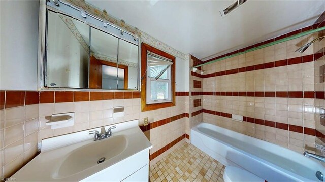3702 Nansemond Pkwy, Suffolk, VA 23435 - full bath with tile walls, bathing tub / shower combination, vanity, toilet, and tile patterned flooring
